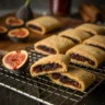Homemade fig newtons on cooling rack with fig filling
