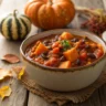 Butternut squash chili with beans and tomatoes in a rustic bowl