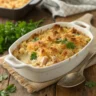 Tuna casserole topped with breadcrumbs and parsley in a baking dish