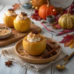 Baked apples stuffed with pumpkin pie filling topped with whipped cream