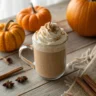 Mug of pumpkin spice latte topped with whipped cream and cinnamon