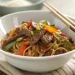 Homemade Beef Lo Mein – Tender Noodles and Savory Sauce 9 Bowl of beef lo mein noodles with vegetables and soy sauce