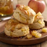 Stack of fluffy apple biscuits topped with melting honey butter