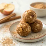 Close-up of apple pie protein balls showing oats, cinnamon, and dried apple pieces
