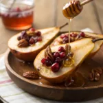 Baked pear halves with honey, cranberries, and pecans