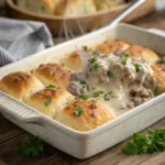 Biscuits and gravy casserole with creamy sausage gravy and melted cheese