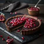 Chocolate tart topped with fresh pomegranate arils