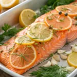 Baked citrus herb salmon fillet topped with fresh herbs and citrus slices