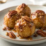 Plate of bite-sized Pecan Pie Balls with caramel drizzle