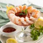 Shrimp Cocktail with cocktail sauce and lemon wedges