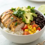 Chicken burrito bowl with rice, beans, avocado, and chicken