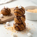 S’mores protein balls stacked with chocolate drizzle