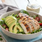 Grilled chicken avocado salad with fresh greens