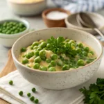Green peas in a creamy butter sauce garnished with herbs