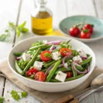 Fresh green bean salad with cherry tomatoes, feta, and red onions