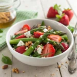 Strawberry asparagus salad with mixed greens, feta, and nuts