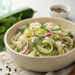 Cucumber pasta salad with dill and creamy dressing in bowl