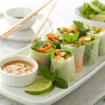 Fresh avocado summer rolls with vegetables and dipping sauce