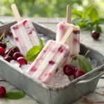 Cherry yogurt popsicles with swirls of cherry and creamy yogurt