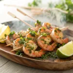 Grilled shrimp skewers with herbs and lemon wedges