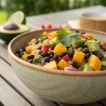 Quinoa salad with mango, black beans, avocado, and vegetables