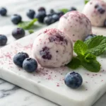 Frozen blueberry Greek yogurt balls with fresh blueberries and creamy center