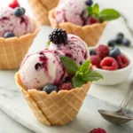 Creamy mixed berry ice cream with fresh berries and colorful fruit swirls