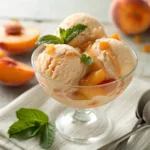 Creamy peach ice cream scoops with fresh peach slices and syrup
