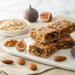 Homemade no-bake fig energy bars made with oats, nuts, and dried figs on a serving plate.