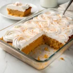 Moist pumpkin tres leches cake soaked in a creamy milk mixture and topped with whipped cream and cinnamon.
