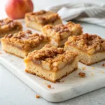 Homemade salted caramel apple pie bars with buttery crust, cinnamon apples, crumble topping, and caramel drizzle.