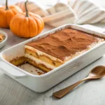 Homemade pumpkin tiramisu with layers of ladyfingers, pumpkin mascarpone cream, and cinnamon dusting.