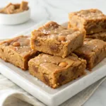 Homemade salted butterscotch blondies with chewy centers, golden edges, butterscotch chips, and flaky sea salt.